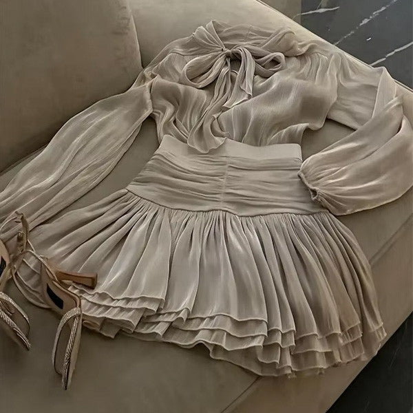 Sheer Bow Blouse and Pleated Mini Skirt in Soft Taupe