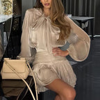 Sheer Bow Blouse and Pleated Mini Skirt in Soft Taupe