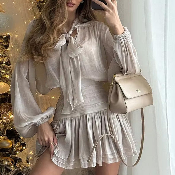 Sheer Bow Blouse and Pleated Mini Skirt in Soft Taupe